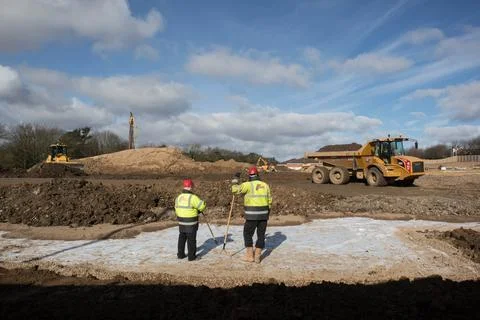 Workers in high vis jackets and hard hats on a construction site Stock Photos