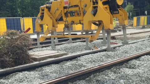 Workers in high visibility gear carry out track renovation alongside heavy Stock Footage 344331239