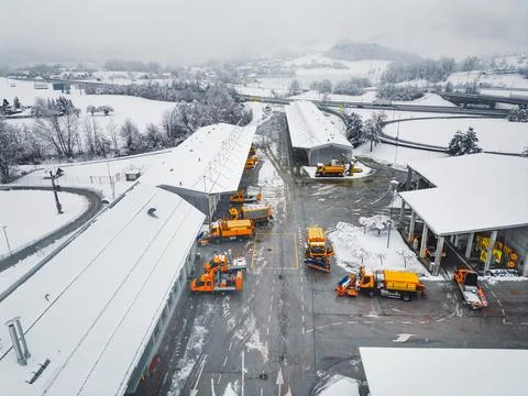 Workers on the highway maintenance base having a busy day, with snow causing Stock Photos