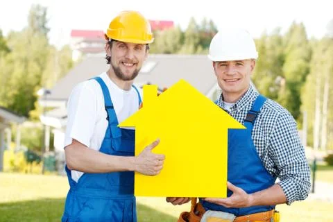 Workers with house model Stock Photos