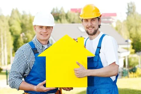 Workers with house model Stock Photos
