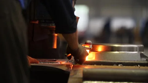Workers inserting hammering red-hot metal pin into object in metal workshop. Video stock 313815316