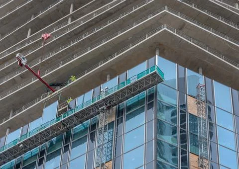 Workers inserting windows on a high-rise building, Frankfurt am Main, Germany Stock Photos