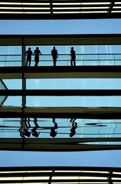 Workers inside the modern building in silhouette. Stock Illustration
