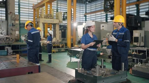 Workers inspect machinery in a bustling factory floor Stock Footage 341925697