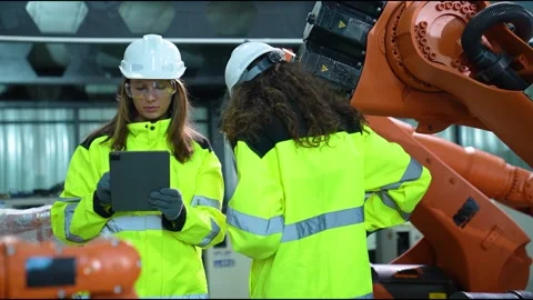 Workers inspect robotic arms daytime hours Stock Footage 306633367