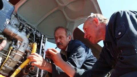 Workers inspect the tubes in the motor. Stock Footage 81530820