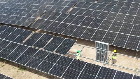 Workers inspecting solar panels at a solar farm, aerial view Stock Footage 278368022