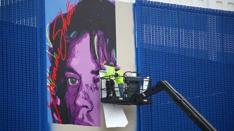 Workers install advertising billboard using motorized lift in Los Angeles Stock Footage 32282821