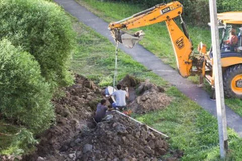 Workers install the element of the well. Stock Photos
