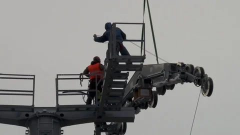 Workers install multi-ton metal structure on support with Ka-32 helicopter. Stock Footage 106111306