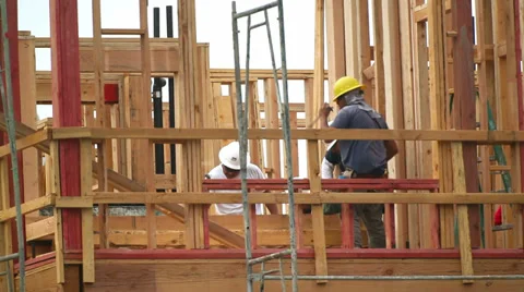 Workers install structural elements inside of frame at construction site 스톡 동영상 34534288
