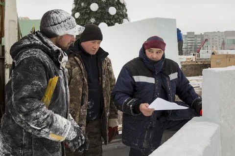 Workers on the installation of the ice town 스톡 사진