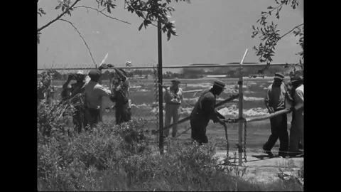 Workers installing chain link fence - 1940 Stock Footage 107124035