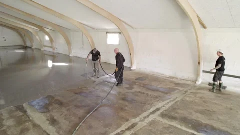 Workers Installing Epoxy Floor Coating in Warehouse Stock Footage 332511477