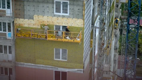 Workers installing insulation at construction site of high-rise building Stock Footage 146502488