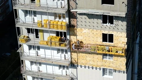 Workers installing insulation at construction site of high-rise building Stock Footage 152800380