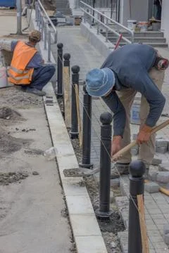 Workers installing posts Stock Photos