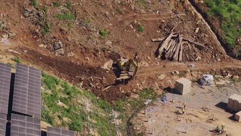 Workers Installing Solar Farm Foundations on a Hillside Construction Site Stock-Footage 344440915