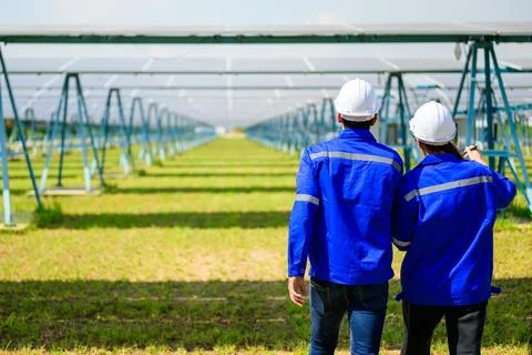 Workers installing solar panels, Engineer team at solar panel farm Stock Photos