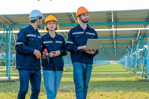 Workers installing solar panels, Engineer team at solar panel farm Stock Photos