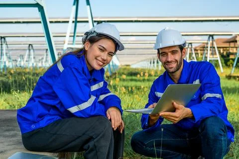 Workers installing solar panels, Engineer team at solar panel farm Stock Photos
