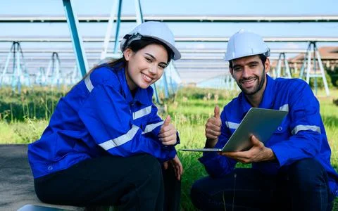 Workers installing solar panels, Engineer team at solar panel farm Stock Photos