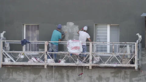Workers insulate the facade of a high-rise residential building Stock Footage 284877990