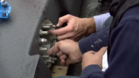 Workers intent to loosen the nuts Stock Footage 70806270