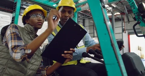 Workers interacting in a warehouse Stock Footage 115995395