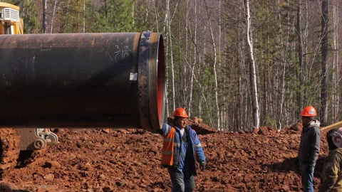 Workers on the interior of a new gas pipe at the construction site. Stock Footage 171878859