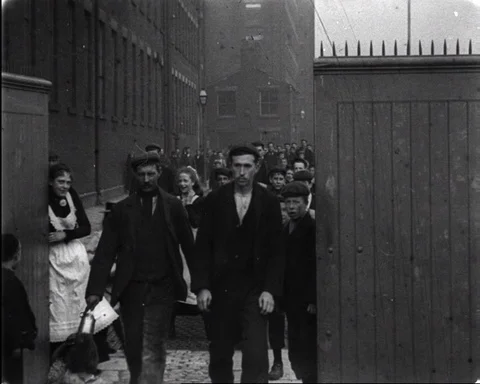 Workers leaving work at North-Street Mills, Chorley 1900 Stock Footage 133372228