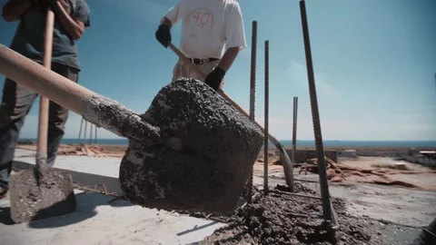 Workers level cement with a shovels on a construction site Stock Footage 143216867