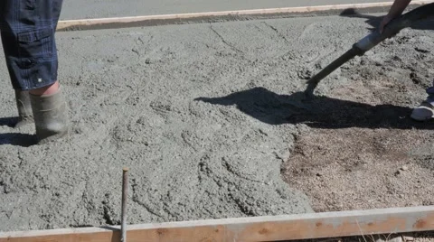 Workers level freshly poured concrete patio Stock Footage 66134189