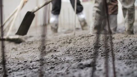 Workers leveling fresh concrete at construction site Stock Footage 315562543