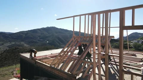 Workers lifting a frame up with a view Stock-Footage 228794964