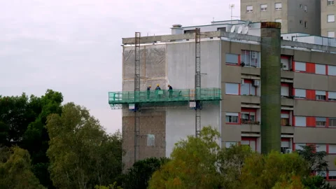 Workers on a lifting platform are carrying out the restoration work on a facade Stock Footage 146483330