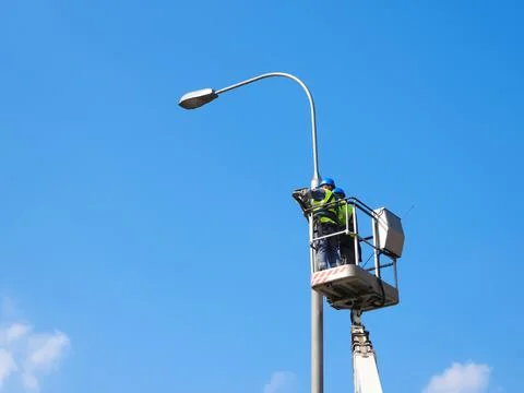 Workers on lifting platform Stock Photos
