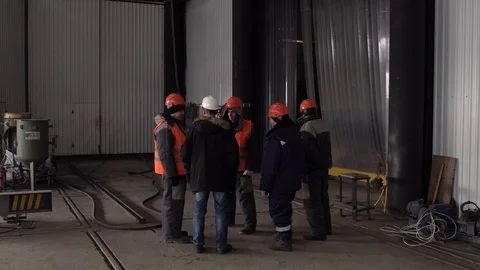 Workers listen to the task from the boss in a white helmet. Stock Footage 104657008