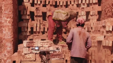 Workers load bicycle with bricks in Dhaka, Bangladesh. Stock Footage 48323993