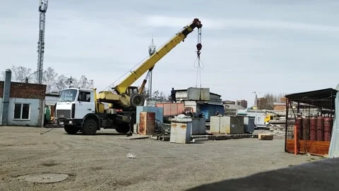 Workers load construction waste into the truck using a crane Stock Footage 273340839