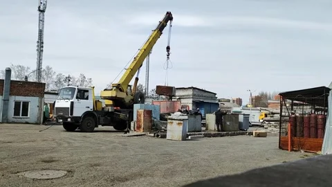 Workers load construction waste into the truck using a crane Stock Footage 273340853