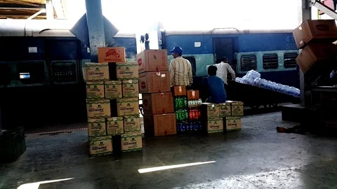Workers Loading Cargo and Packed Water Bottol Into Local Train Stock Footage 108048808
