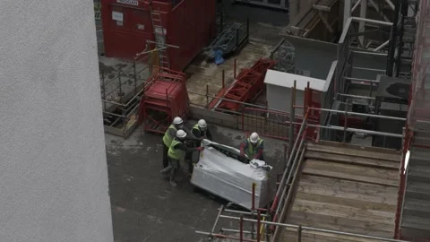 Workers Loading Materials Into Construction Site Elevator In Millbank. 库存影片 143149992