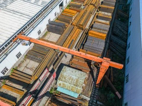 Workers loading stack of metal pipes with gantry crane into the truck Foto stock