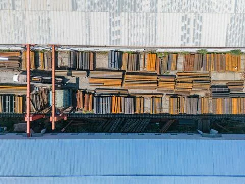 Workers loading stack of metal pipes with gantry crane Stock Photos