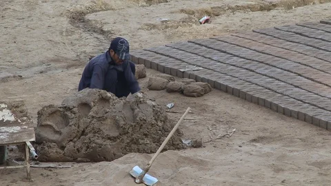 Workers at a local brick factory making bricks in broad day light. Stock Footage 86657773
