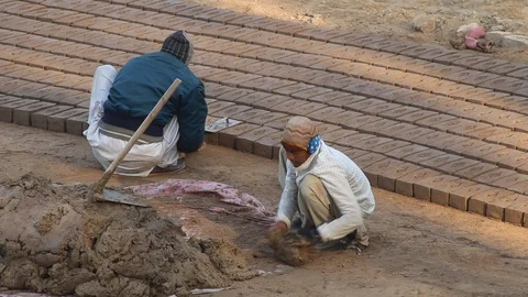Workers at a local brick factory making bricks in broad day light. Stock Footage 86657996