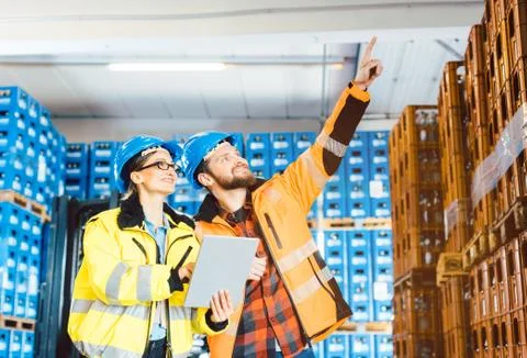Workers in a logistics warehouse planning the next project Stock Photos