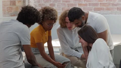 Workers looking at the mobile in group and smiling in a coworking. Stock Footage 158821468